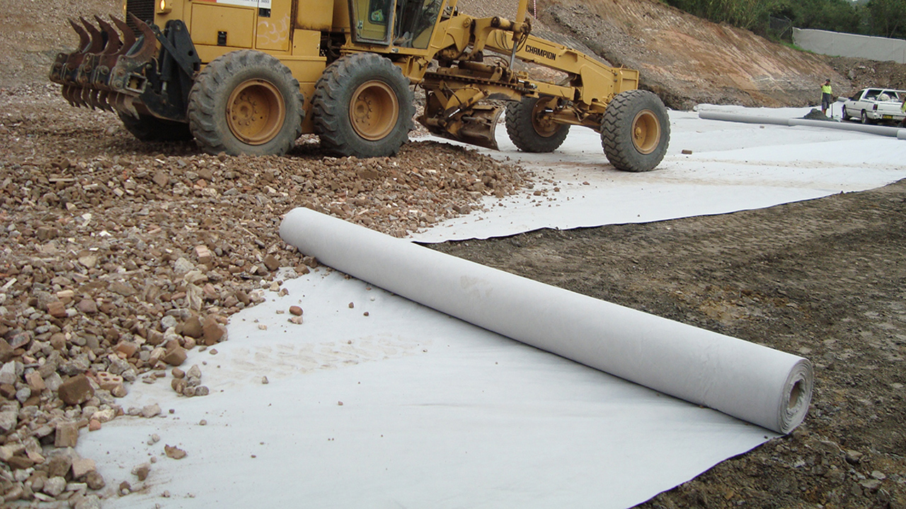 White Non Woven Geotextile and a yellow truck